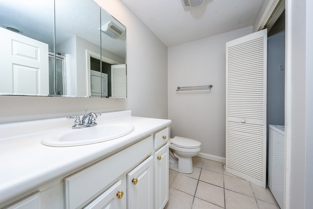13 Pga Lane, Unit 424 Mashpee, MA 02649 - Photo 11 of 19 a bathroom with a sink a toilet and shower