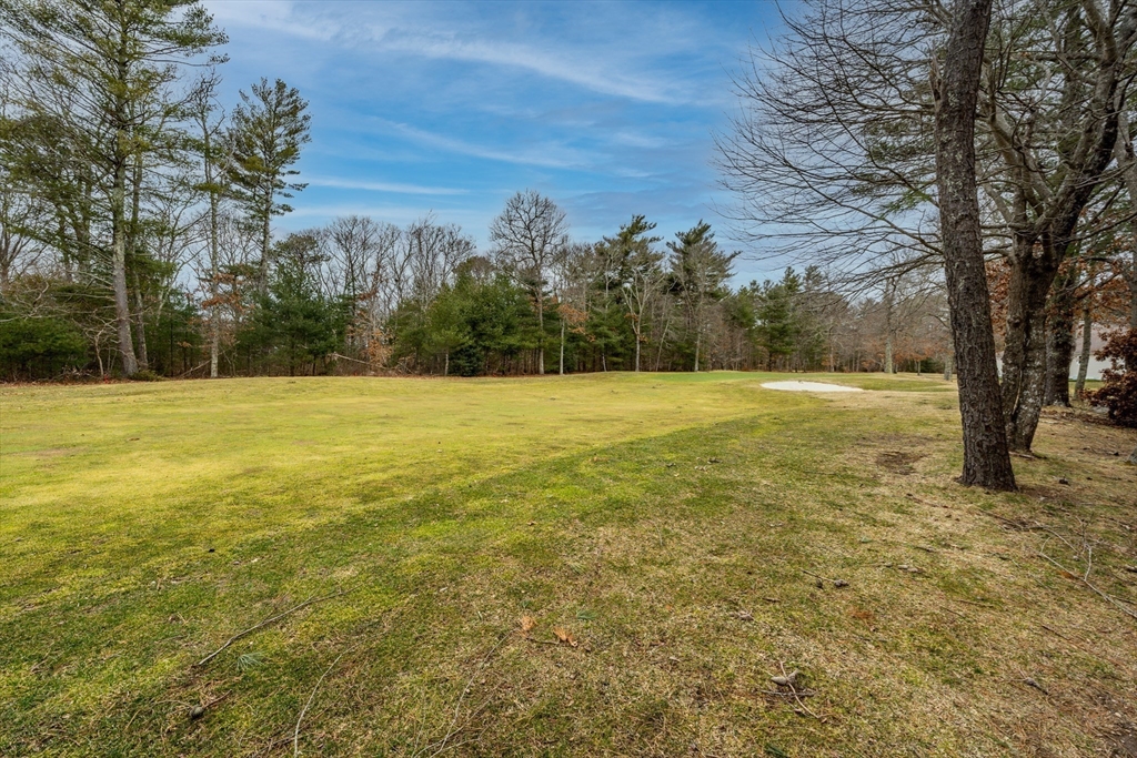 13 Pga Lane, Unit 424 Mashpee, MA 02649 - Photo 17 of 19 a view of a field with an trees in front of it