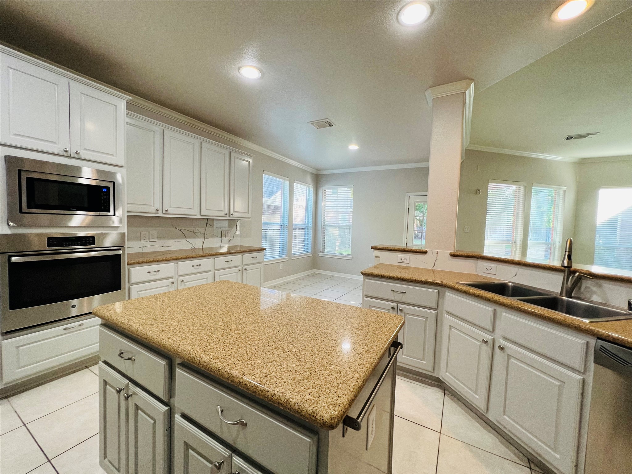 23703 Banning Point Court Katy, TX 77494 - Photo 11 of 30 a kitchen with granite countertop a sink a counter top space appliances and cabinets