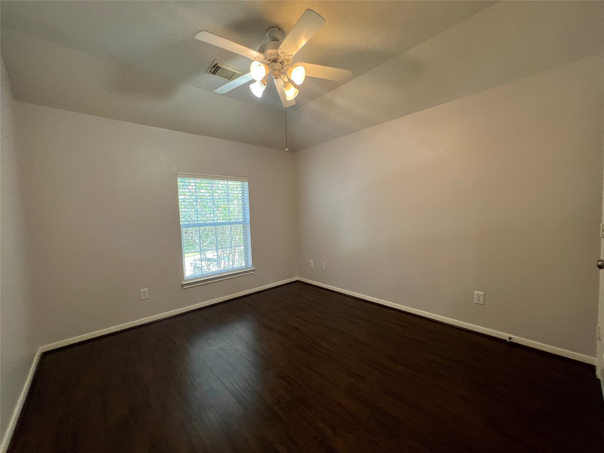 23703 Banning Point Court Katy, TX 77494 - Photo 27 of 30 a view of an empty room with wooden floor and a window
