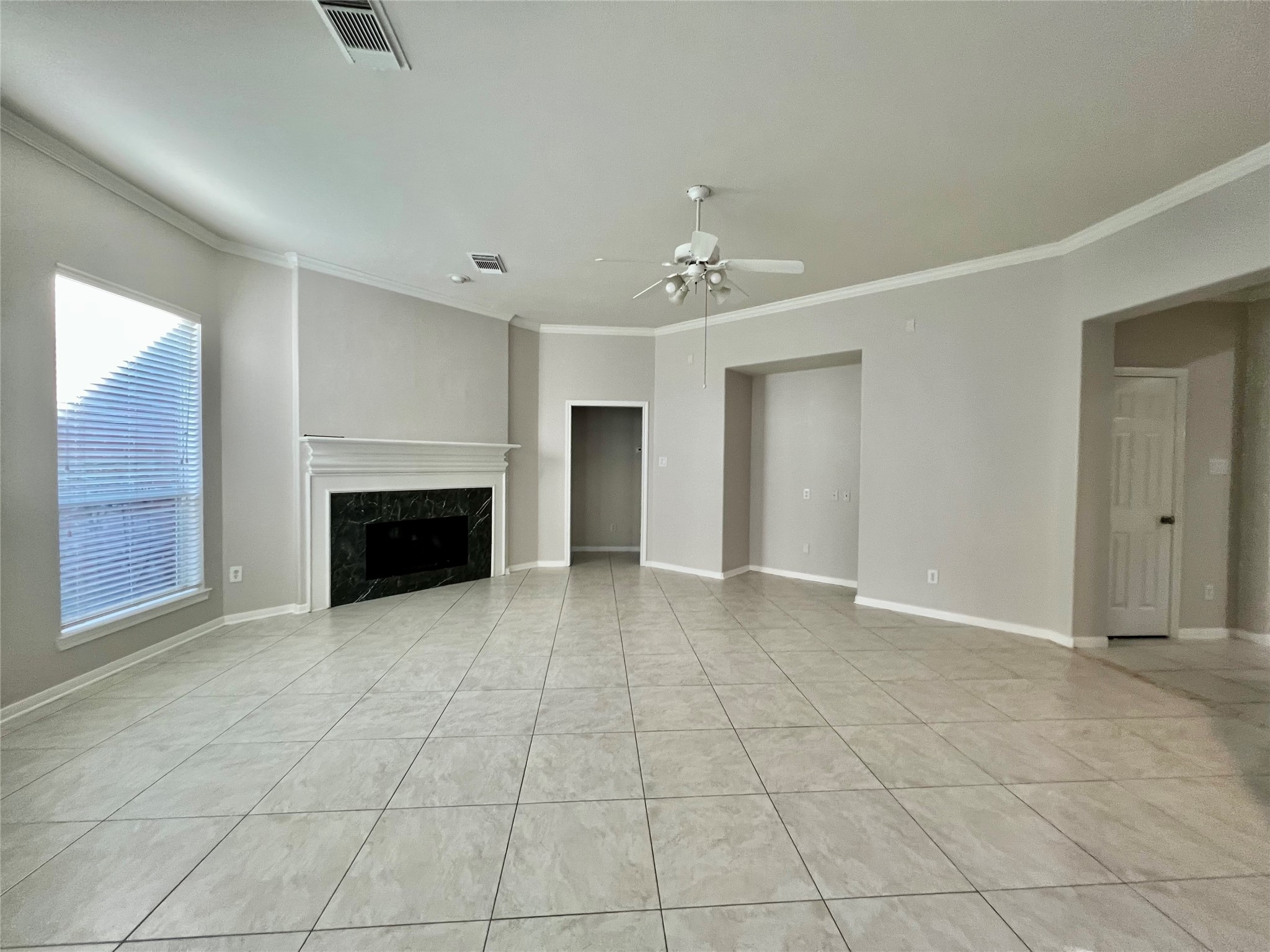 23703 Banning Point Court Katy, TX 77494 - Photo 7 of 30 an empty room with fireplace and fan