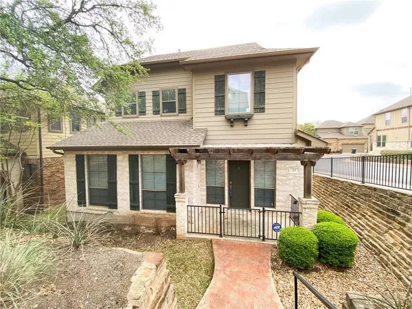 a view of a house with a window and wooden fence