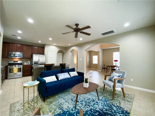 a living room with furniture and kitchen view