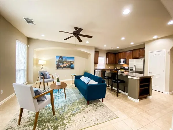 a living room kitchen with furniture and a window