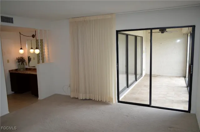 a view of a hallway with closet and a bathroom