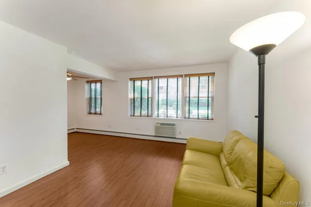 a living room with couches and a large window with outer view