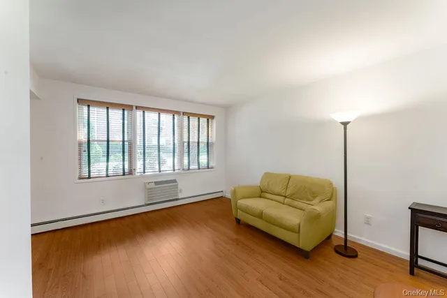 a living room with couch and a window