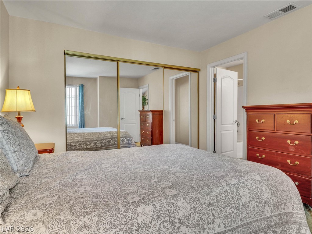 3145 East Flamingo Road, Unit 2129 Las Vegas, NV 89121 - Photo 23 of 43 Ample mirrored closet doors create a feeling of spaciousness in this comfortable bedroom.