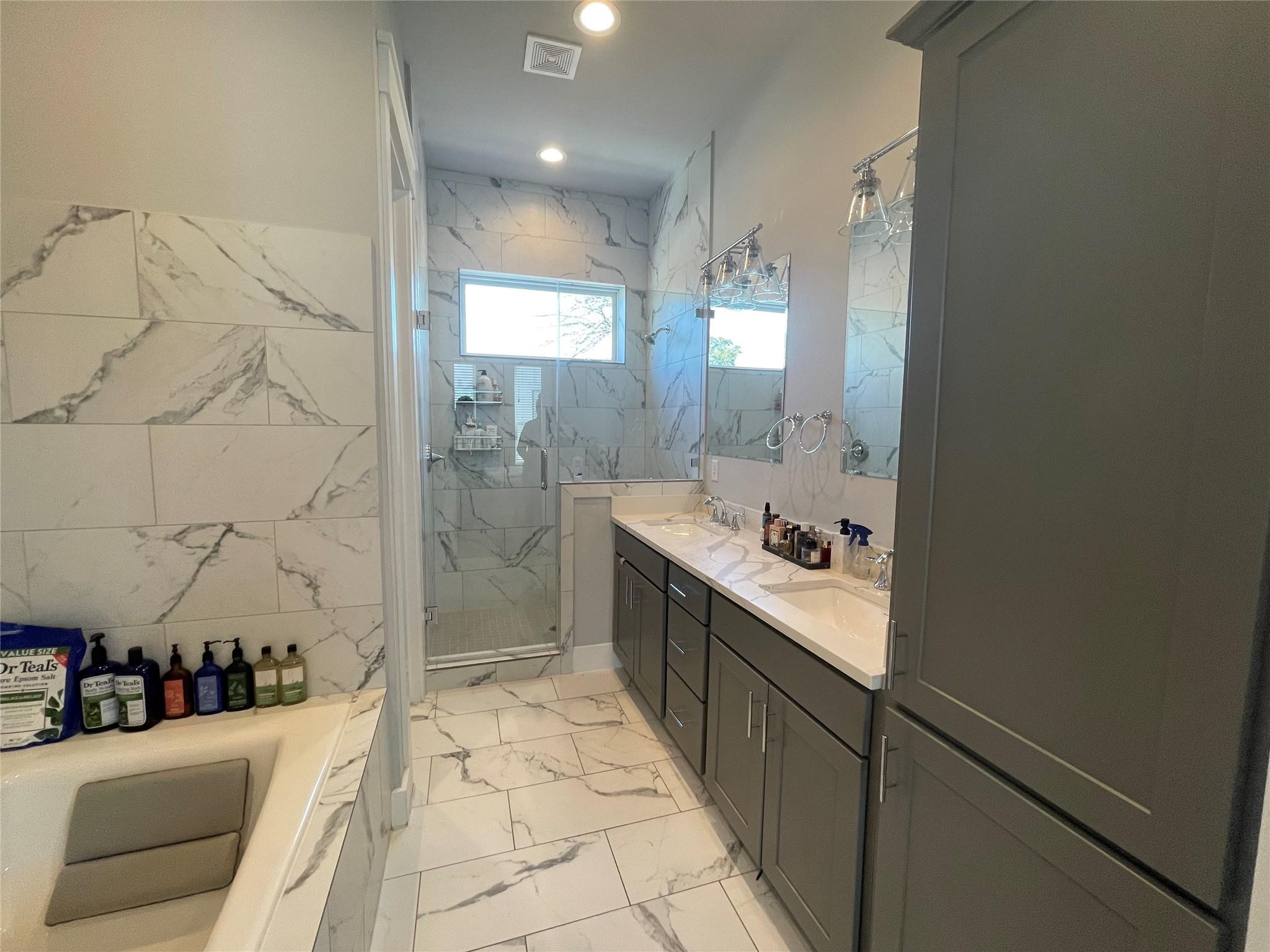 902 Martin Street, Unit A Houston, TX 77018 - Photo 19 of 21 a large bathroom with a tub a sink and a shower