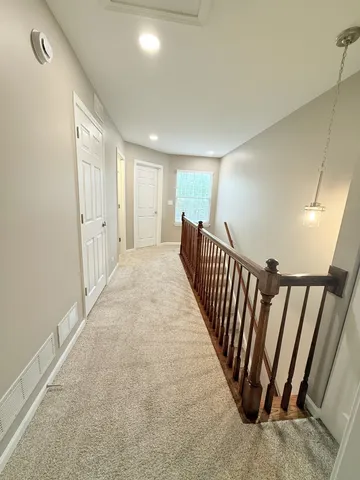 a view of a hallway with stairs