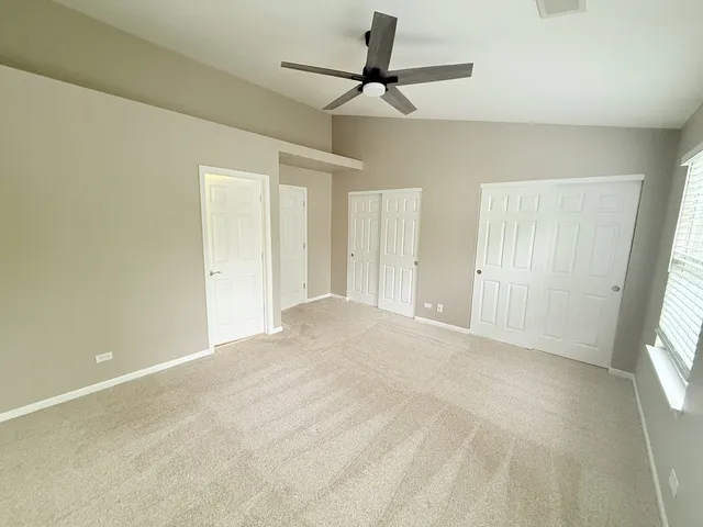 a view of a livingroom with a ceiling fan and window
