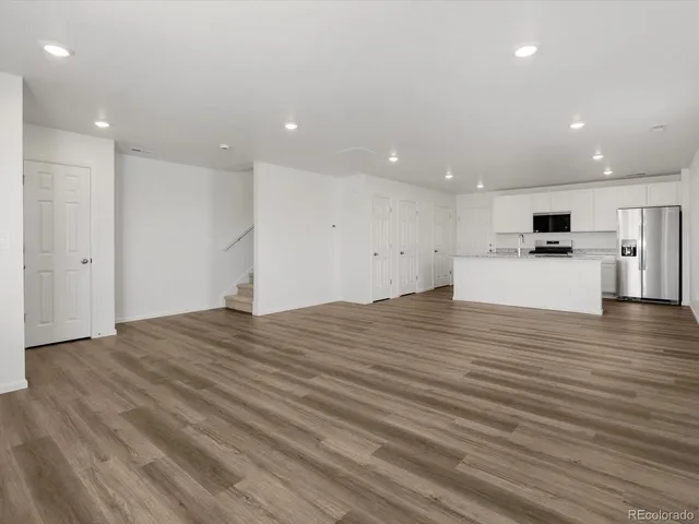 a view of empty room with wooden floor