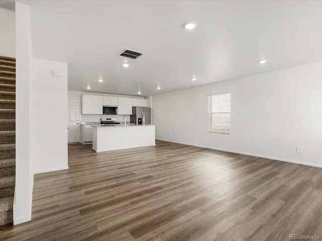 a view of kitchen with cabinets and wooden floor