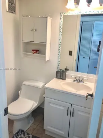 a bathroom with a sink a toilet and mirror