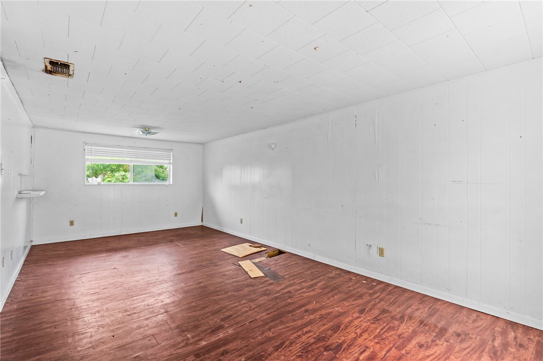 1011 Northcliff Drive Portland, TX 78374 - Photo 3 of 16 an empty room with wooden floor and windows