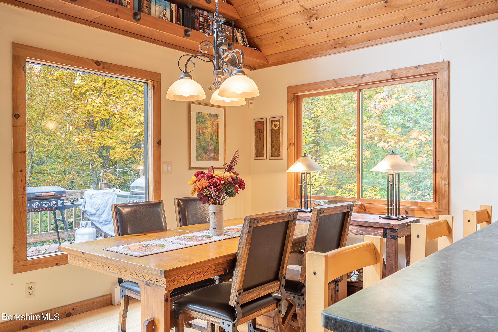 1027 Fred Snow Road Becket, MA 01223 - Photo 22 of 33 a view of a dining room with furniture large windows and wooden floor