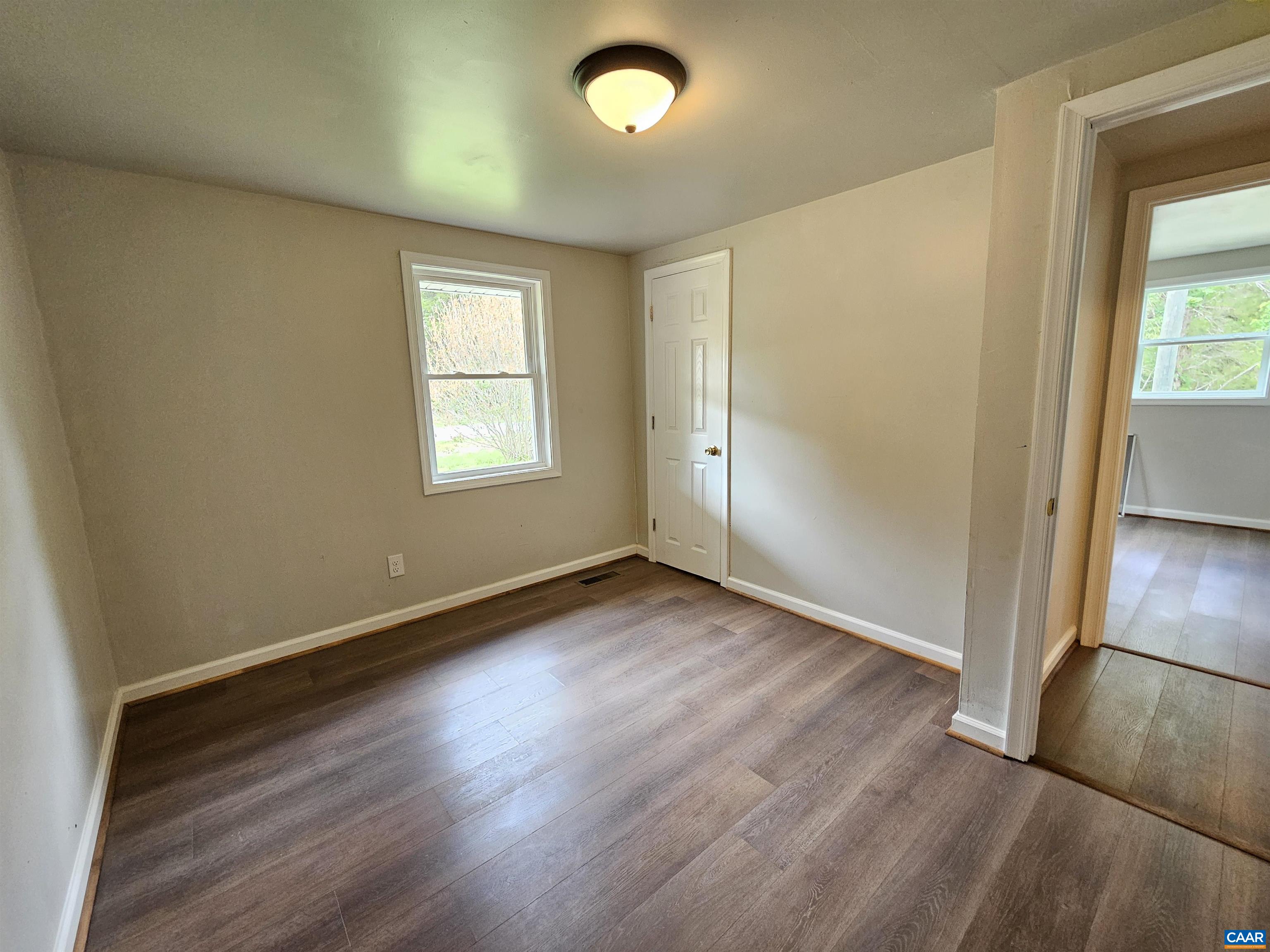 5290 Dixie Hill Road Buckingham, VA 23921 - Photo 18 of 24 an empty room with wooden floor and windows