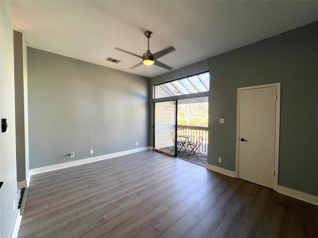3801 Menchaca Road, Unit 50 Austin, TX 78704 - Photo 15 of 30 an empty room with wooden floor fan and windows