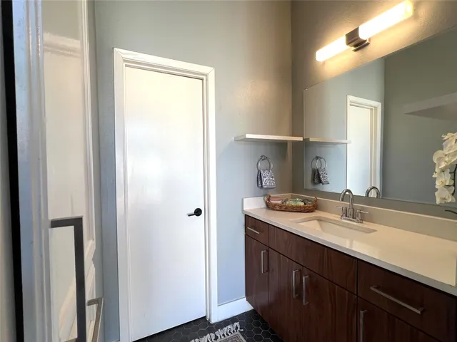 a bathroom with a sink toilet and a mirror