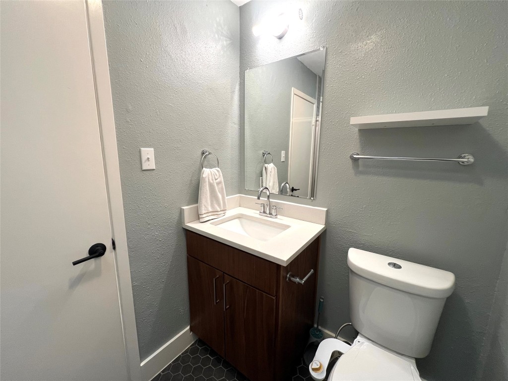 3801 Menchaca Road, Unit 50 Austin, TX 78704 - Photo 19 of 30 a bathroom with a sink toilet and a mirror