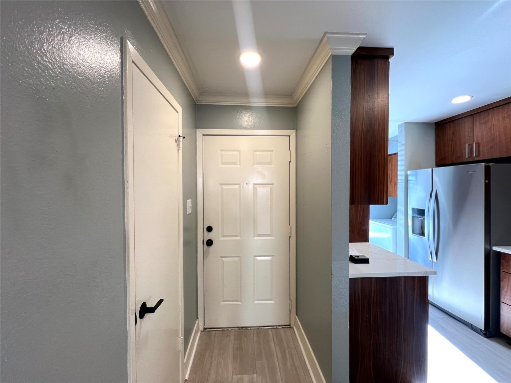 3801 Menchaca Road, Unit 50 Austin, TX 78704 - Photo 4 of 30 a view of a refrigerator in kitchen and wooden floor