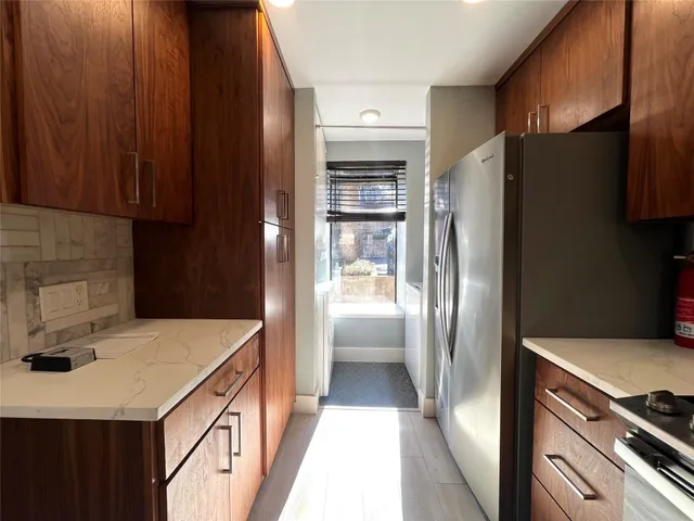 a kitchen with a refrigerator and a sink