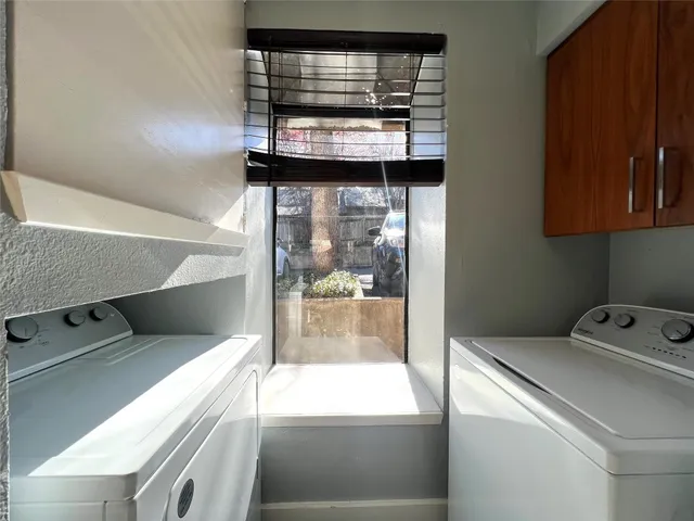 a kitchen with stainless steel appliances granite countertop a refrigerator a stove and a sink