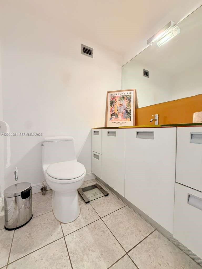 100 Lincoln Road, Unit 1423 Miami Beach, FL 33139 - Photo 14 of 17 a white toilet sitting next to a bathroom sink