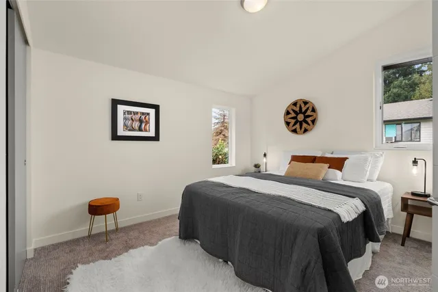 a bedroom with a bed and a painting on the wall