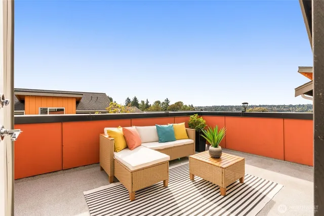 a view of balcony with furniture and city view