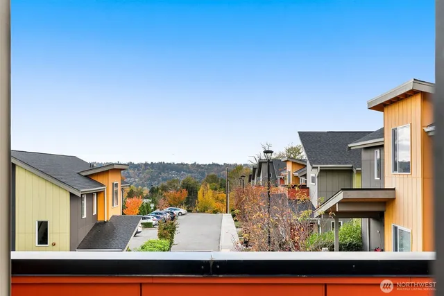 an aerial view of residential houses with outdoor space and trees