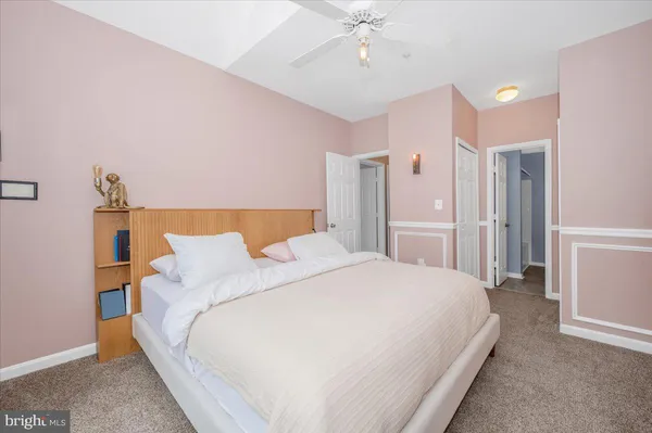 a large bed sitting in a bedroom and a table