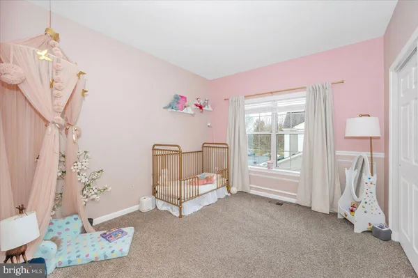 a spacious bedroom with a bed and a window