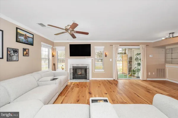 a living room with furniture fireplace and flat screen tv