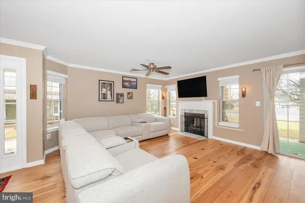 a living room with fireplace furniture and a flat screen tv