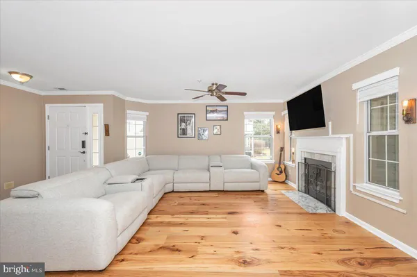 a living room with furniture fireplace and flat screen tv