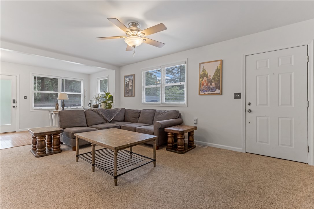 404 Davis Road Liberty, SC 29657 - Photo 14 of 39 A well-lit living space features plush carpeting and multiple windows, providing a comfortable atmosphere for relaxation.