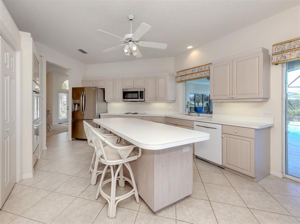 1684 Valley Drive Venice, FL 34292 - Photo 12 of 58 a kitchen with kitchen island a counter top space appliances and cabinets
