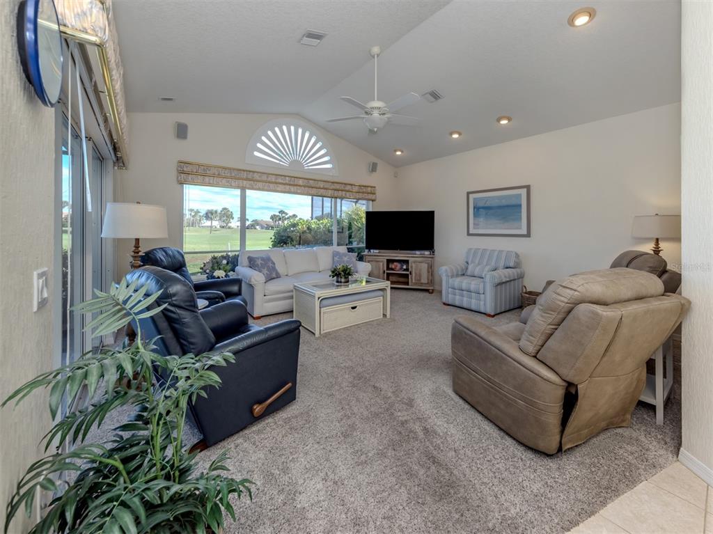 1684 Valley Drive Venice, FL 34292 - Photo 14 of 58 a living room with furniture and a flat screen tv
