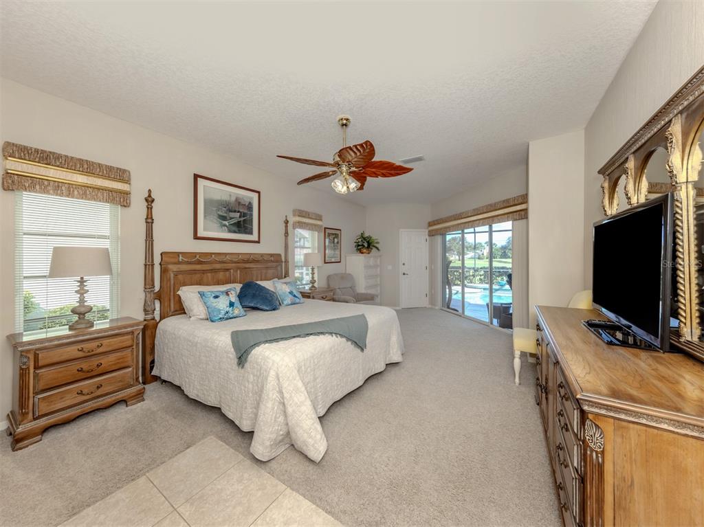 1684 Valley Drive Venice, FL 34292 - Photo 15 of 58 a bedroom with a bed and a flat screen tv