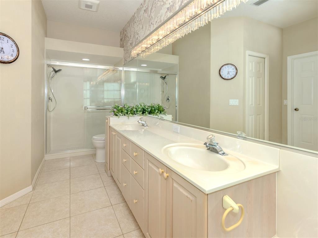 1684 Valley Drive Venice, FL 34292 - Photo 17 of 58 a spacious bathroom with a sink a mirror and a shower
