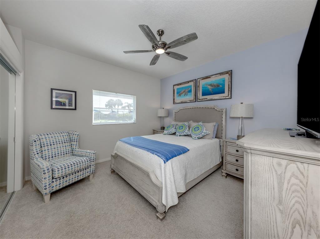 1684 Valley Drive Venice, FL 34292 - Photo 18 of 58 a bedroom with a bed and a couch