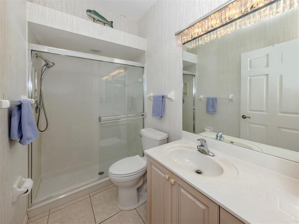 1684 Valley Drive Venice, FL 34292 - Photo 19 of 58 a bathroom with a sink toilet and shower