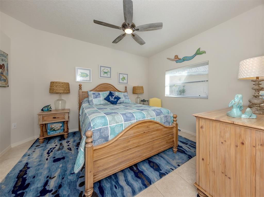 1684 Valley Drive Venice, FL 34292 - Photo 20 of 58 a bedroom with a bed and wooden floor