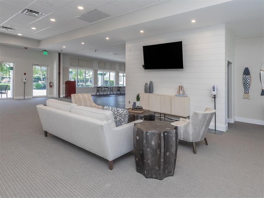 1684 Valley Drive Venice, FL 34292 - Photo 31 of 58 a living room with furniture and a flat screen tv