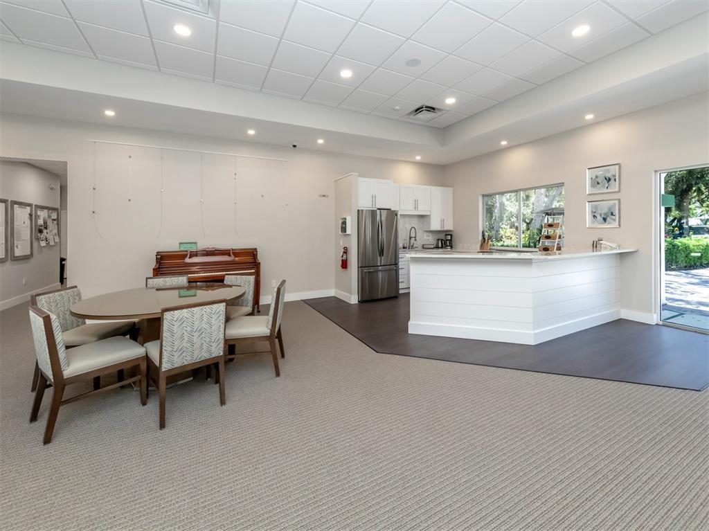 1684 Valley Drive Venice, FL 34292 - Photo 34 of 58 a kitchen with a refrigerator and a dining table