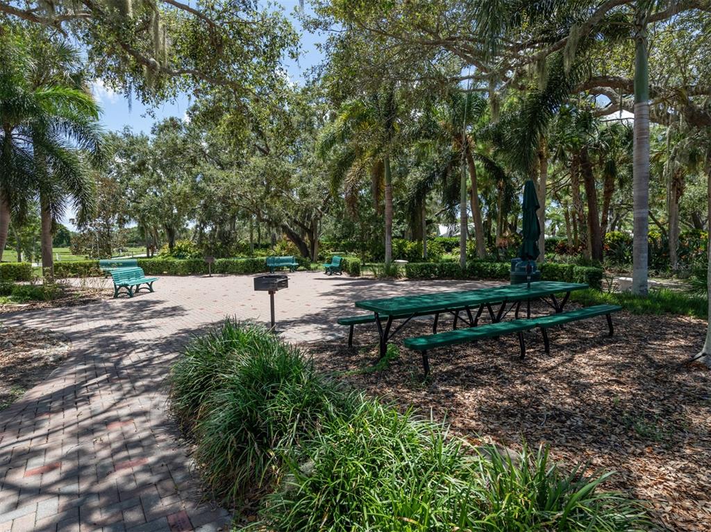 1684 Valley Drive Venice, FL 34292 - Photo 38 of 58 a view of park benches sitting below a tree