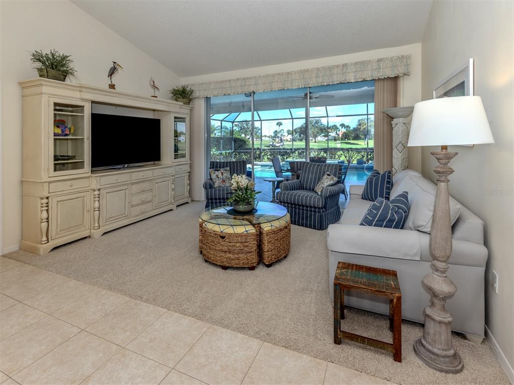 1684 Valley Drive Venice, FL 34292 - Photo 8 of 58 a living room with furniture and a flat screen tv