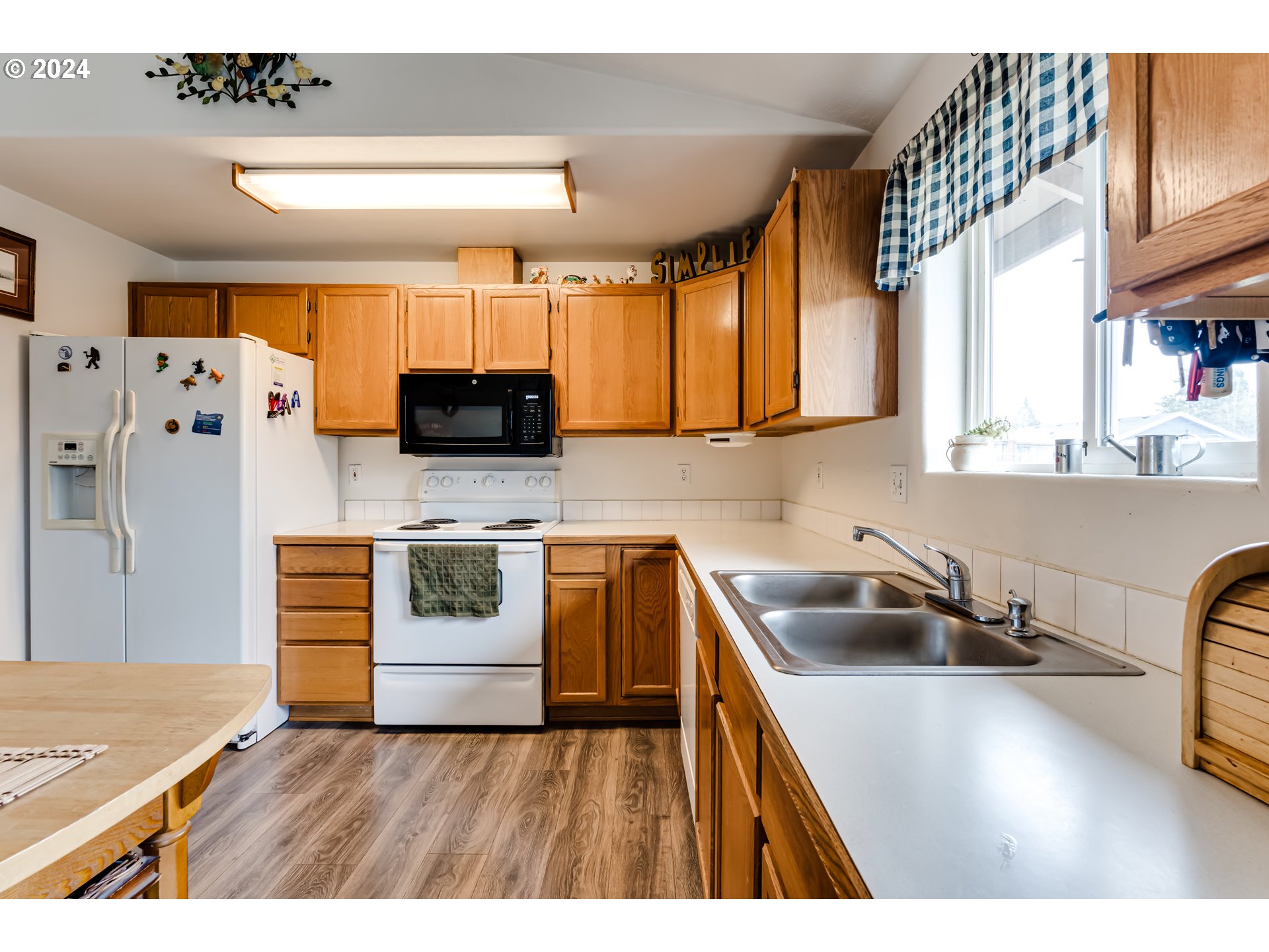 895 Aldridge Place Springfield, OR 97478 - Photo 8 of 19 a kitchen with stainless steel appliances a stove a sink a refrigerator and cabinets