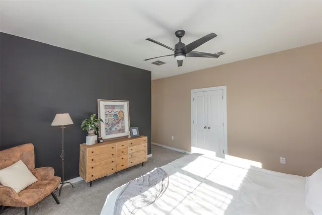 a bedroom with a bed and a chair